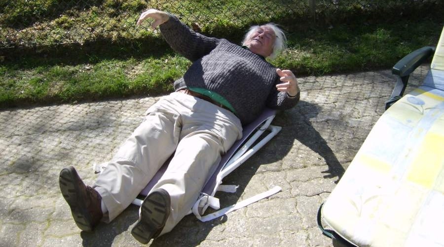 Man on broken garden chair